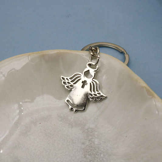 Silver-tone angel keychain with openwork wings and cross detail